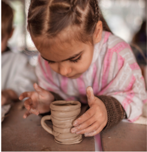 child making pottery