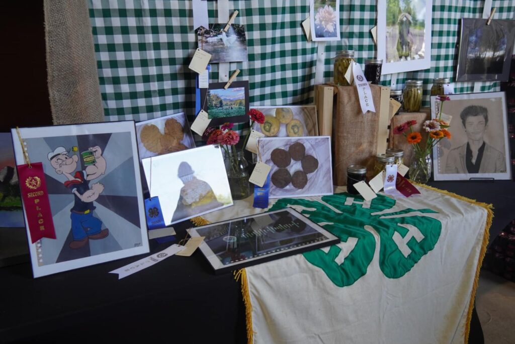 Arts and photographs displayed on a table.